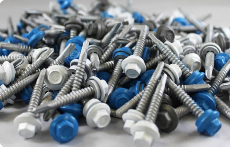 A pile of fasteners for a variety of industries and jobs, with blue and white bolt heads